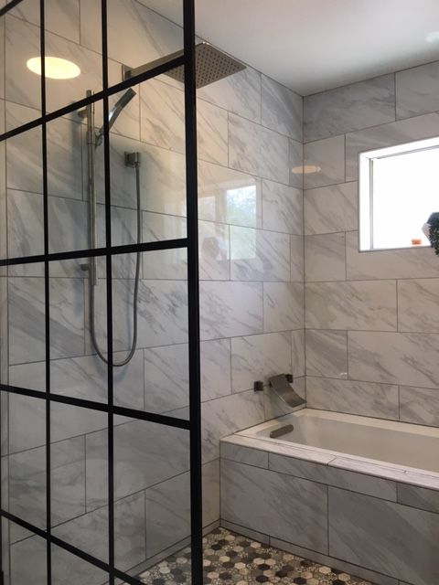 Faux marble wetroom with large shower and deep soaking tub in relatively small 5' x 5' space