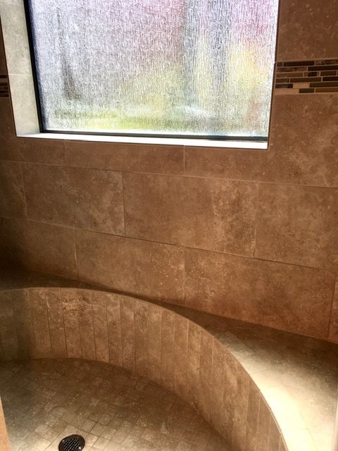 Half round tile shower pan and bench with genius level tile work
